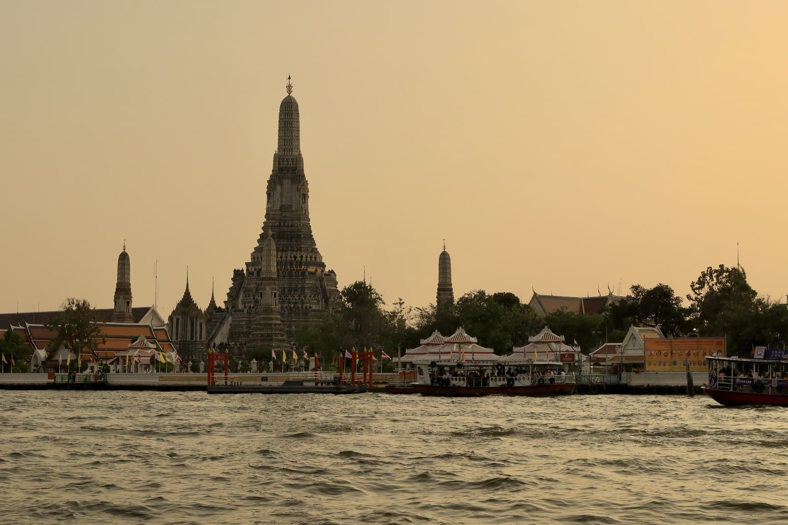 Wat Arun temple across the Chao Phraya River at sunset, Bangkok