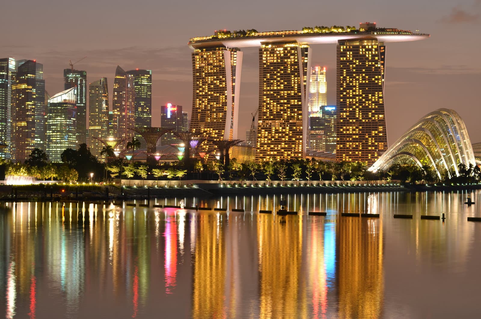 Marina Bay Sands and Gardens by the Bay reflected in the water at dusk, Singapore