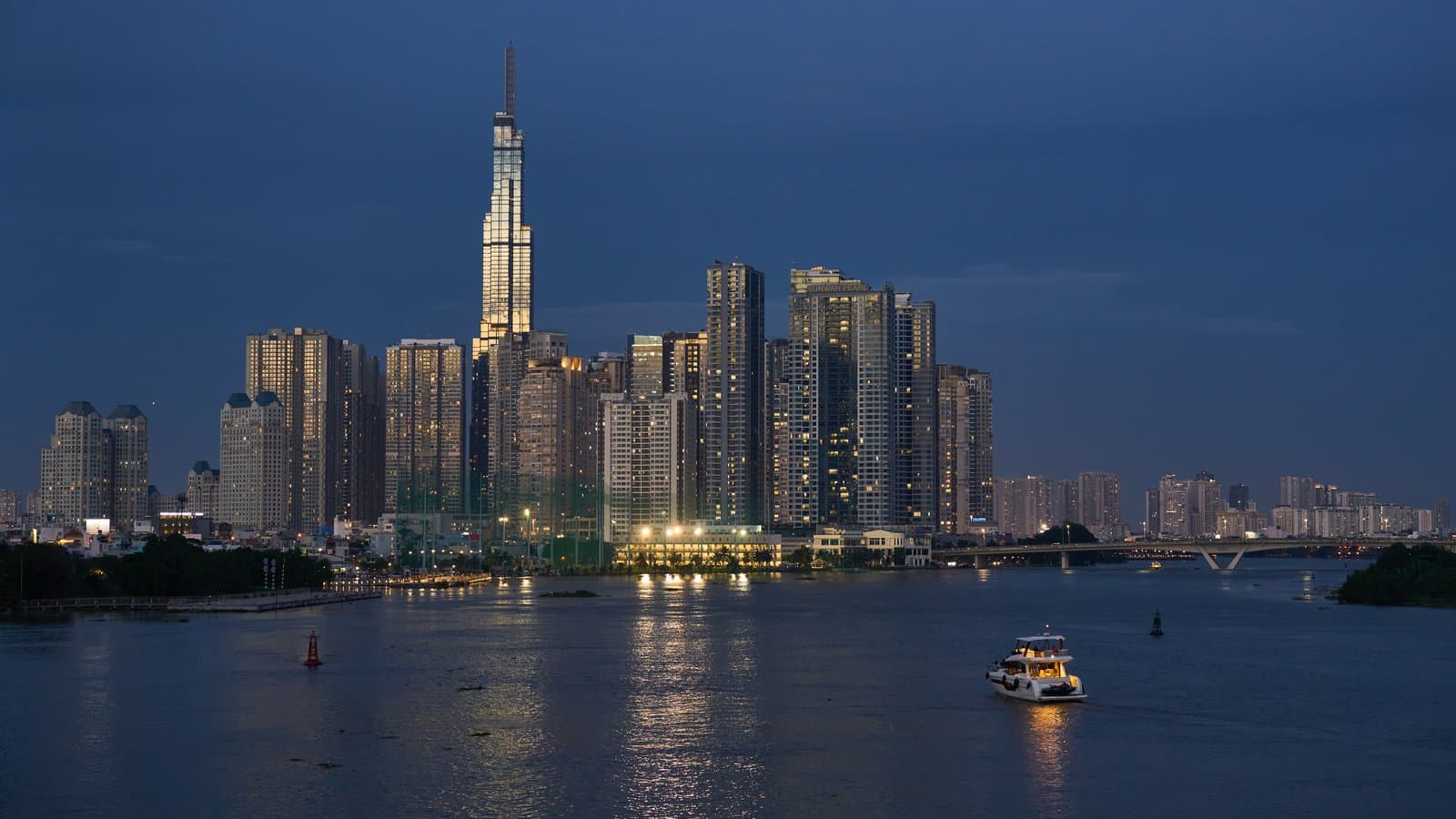 Ho Chi Minh City at blue hour, with Landmark 81 rising above the Saigon River skyline.